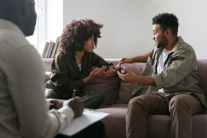 Couple showing tense facial expressions during conversation indicating relationship stress