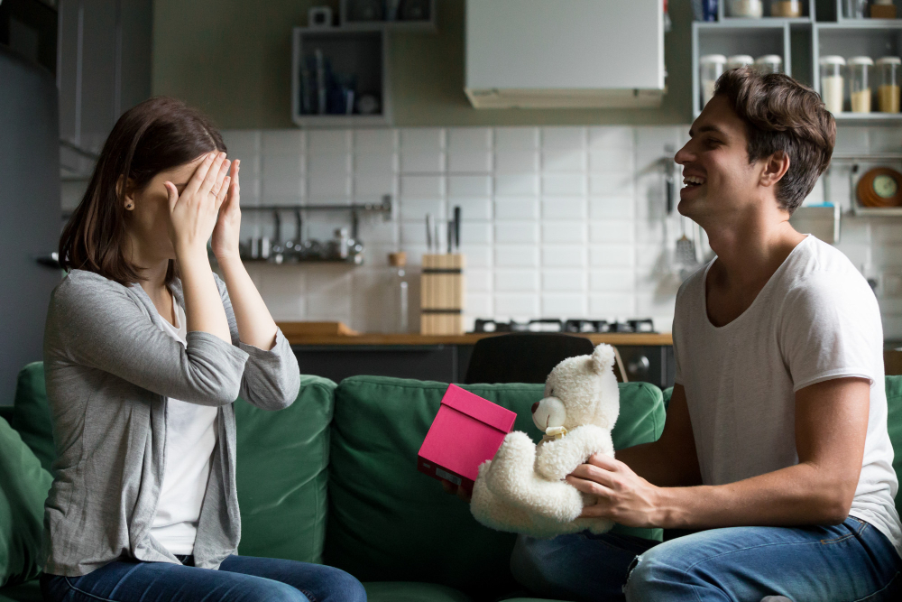 Couple sharing an emotional and positive moment at home after working through unresolved relationship issues and gaining clarity through therapy.
