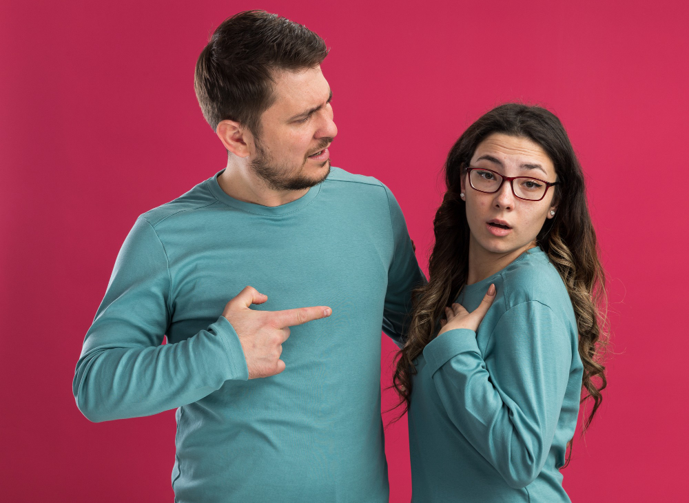 Couple arguing and showing signs of contempt in a relationship, including criticism, blame, and emotional disconnection.