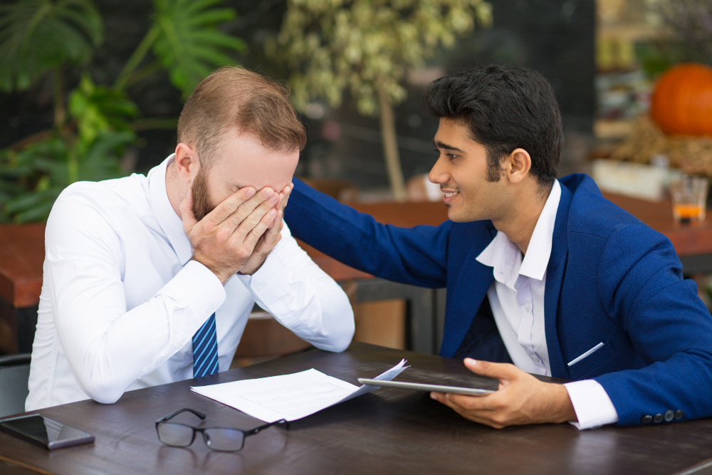 Partner appearing emotionally distressed during a relationship conversation while the other offers support, illustrating the emotional loneliness and frustration that can result when difficult conversations are repeatedly avoided.