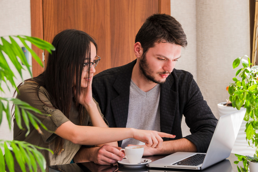 Couple discussing a sensitive issue while reviewing information together, illustrating strategies for approaching a partner who avoids difficult conversations and improving relationship communication.