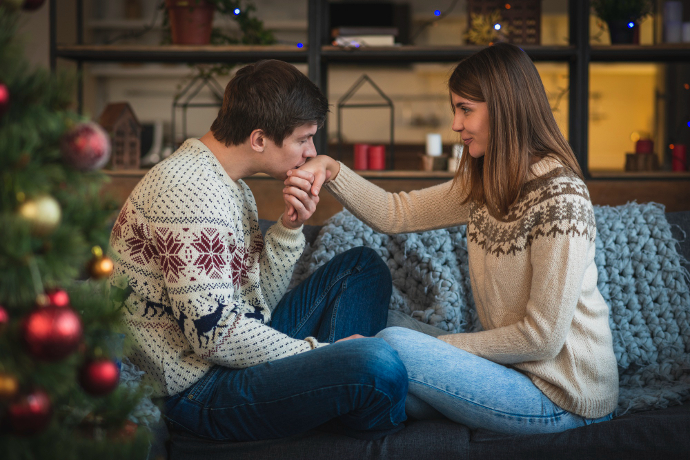 Couple showing affection and emotional connection while sitting together on a couch, illustrating how love alone may not sustain a relationship without healthy communication, compatibility, and mutual effort.