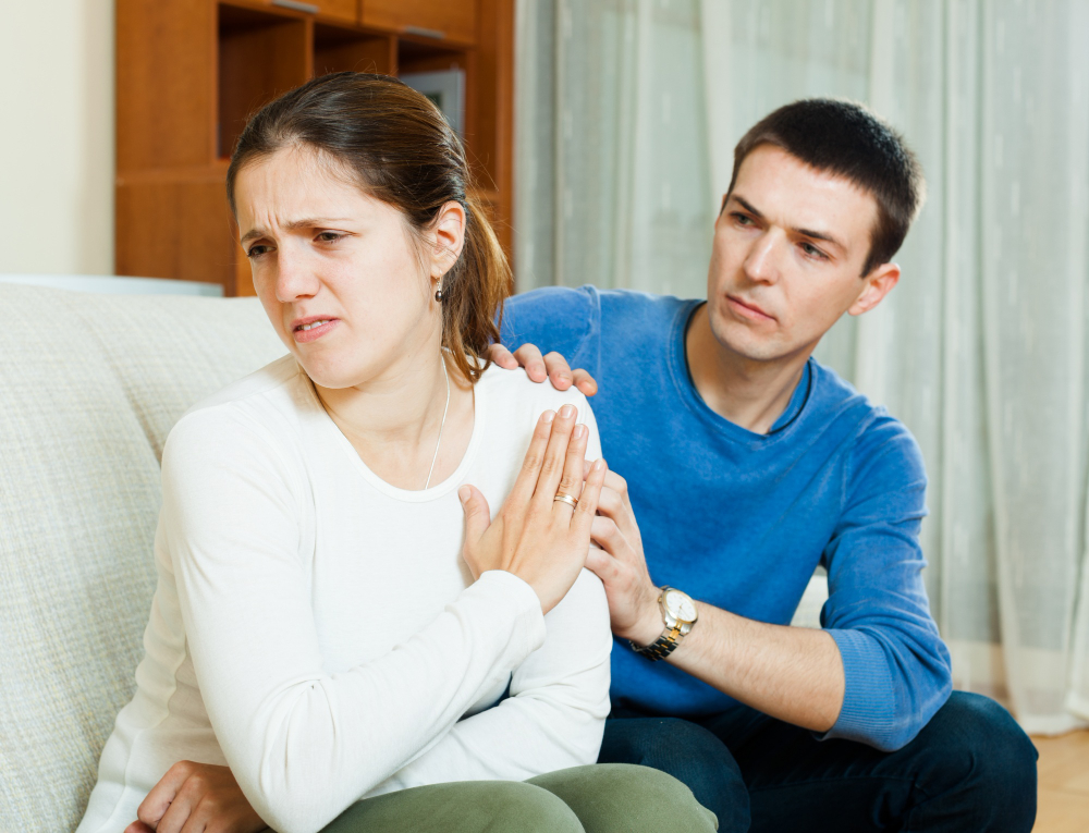 Partner appearing emotionally dismissed and unheard during a difficult conversation, illustrating the feelings of invalidation and disconnection often associated with Cassandra Syndrome in marriage.