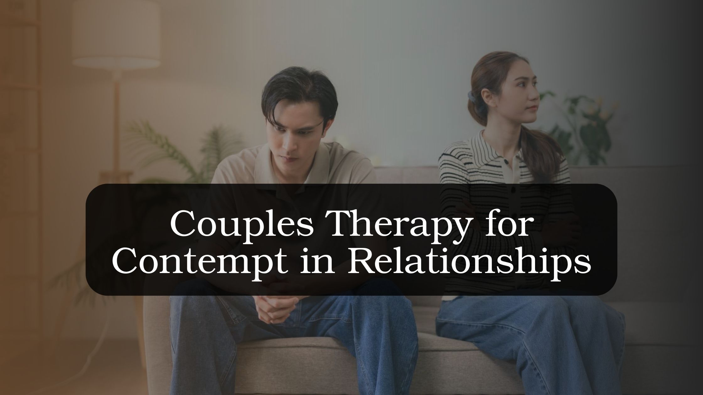 Couple sitting apart on a couch with tense expressions, illustrating contempt in a relationship, emotional distance, disrespectful communication, and the need to rebuild trust and emotional safety.