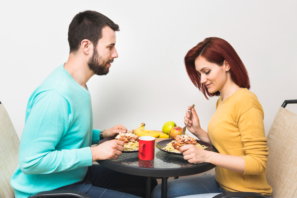 Couple sharing a meal together to strengthen respect, appreciation, and emotional connection through everyday relationship habits.